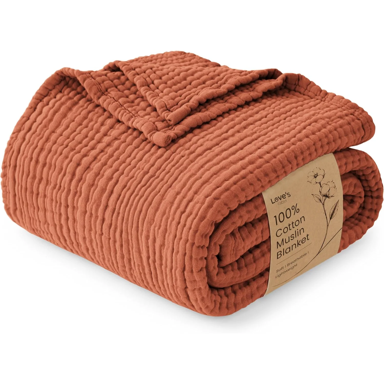Cotton muslin blanket in terracotta, rolled with its kraft band