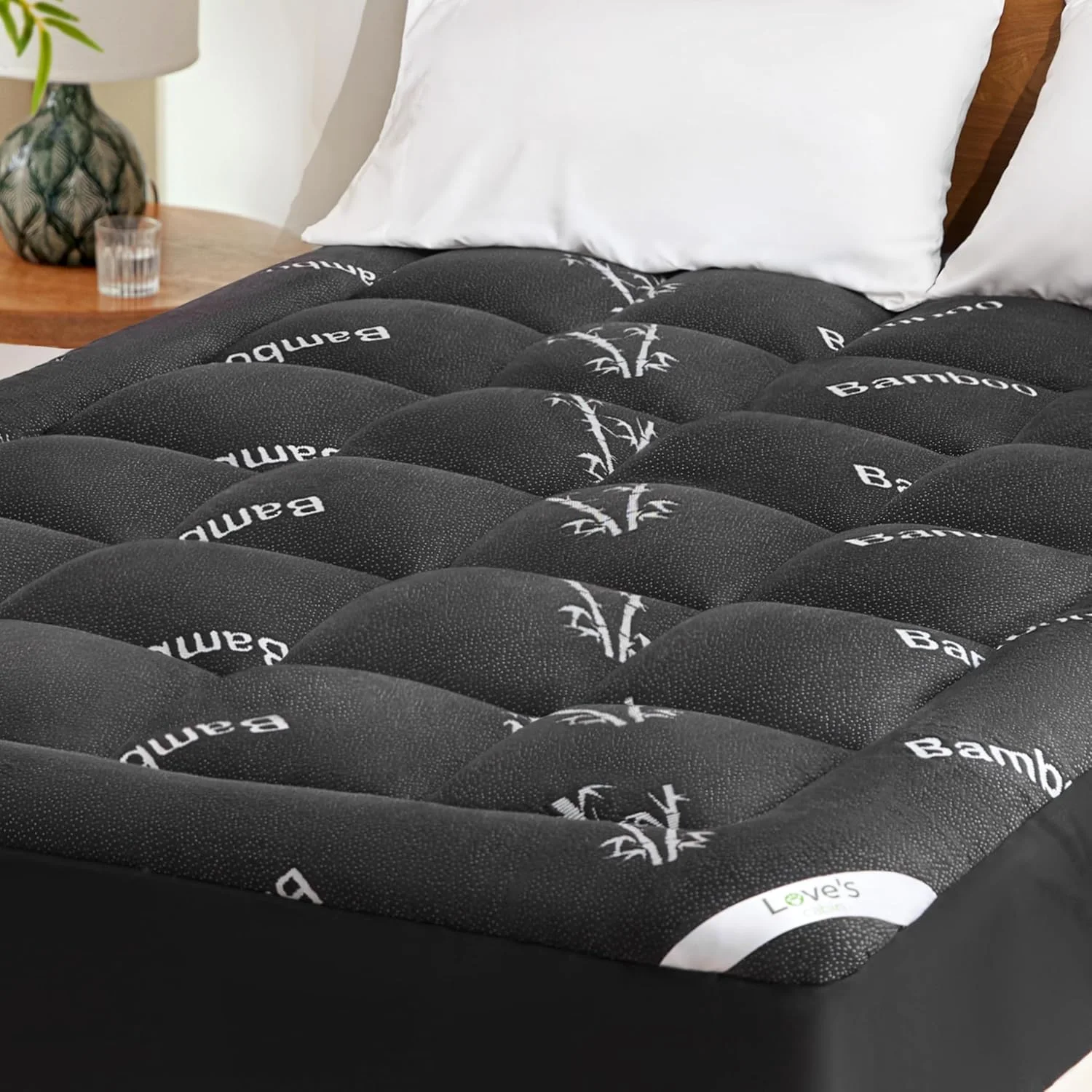 Black bamboo mattress topper under a white pillow